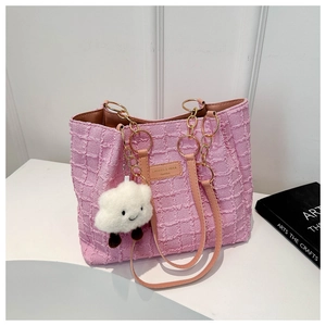 Pink tweed tote bag detail with gold chain strap and cute white cloud charm