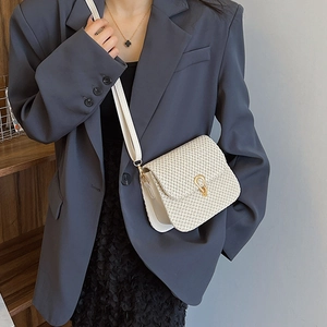 Fashionable cream woven flap crossbody bag with a unique gold clasp and slender strap