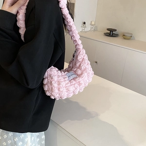 Light pink bubble textured shoulder bag with LOVE FASHION label shown on model