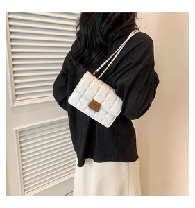 White quilted crossbody bag with gold hardware shown on model for size and fit