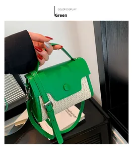 Detail of green leather and woven straw mini bag featuring a decorative round snap button