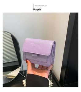 Détail du sac à main violet à paillettes montrant la texture et la chaîne argentée