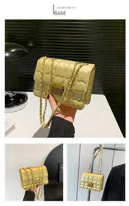 Close-up of golden quilted handbag with cloud texture and metallic chain strap detail