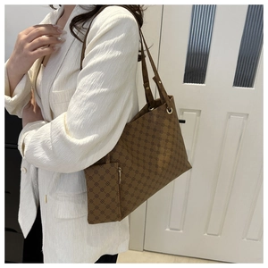 Detailed view of dark brown tote bag with geometric print and matching small pouch