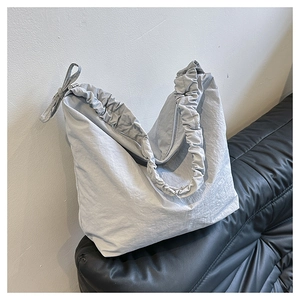 Minimalist light grey nylon drawstring crossbody bag with chic ribbon bow detail