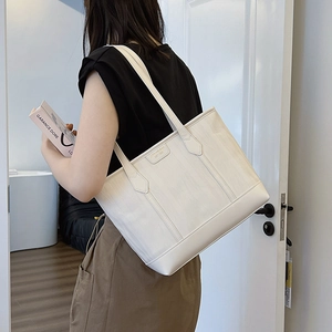 White retro tote bag with brushed texture shown in a minimalist urban commute setting