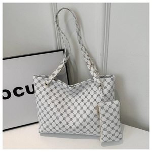 Detailed view of white faux leather tote bag and coin purse with black rhombic pattern