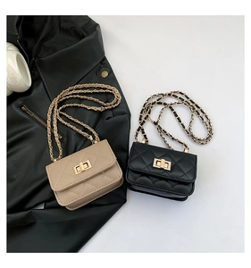 Close-up of classic quilted chain bags with gold twist locks in beige and black colors