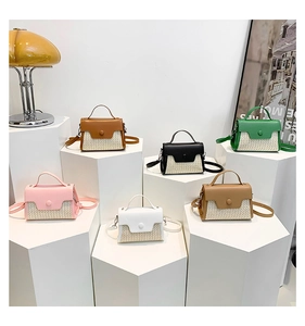 Collection of mini straw patchwork crossbody bags in multiple colors on white stands