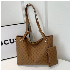 Detail of brown monogram tote bag with matching small zippered hanging pouch