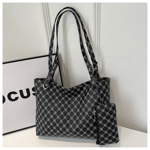 Detail view of large printed tote bag with matching zipper pouch in black and white pattern