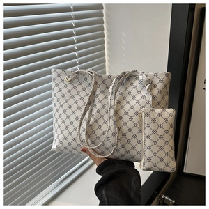 Detailed view of white monogram tote bag set with matching zipper pouch and long handles
