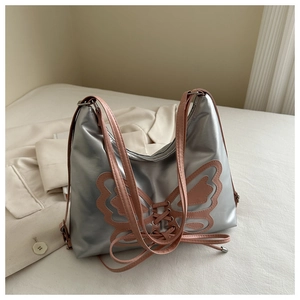 Silver metallic shoulder bag with pink butterfly patch and ribbon tie detail