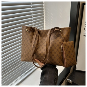 Close-up of brown geometric print tote bag with a matching mini zipper pouch