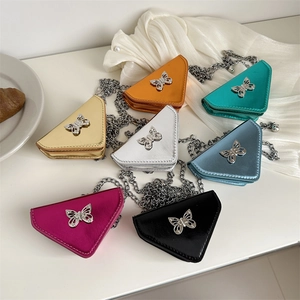 Mini triangle chain bags with bow ornaments shown in seven metallic colors on white background