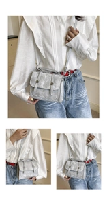 Close-up of silver metallic textured handbag with decorative straps and adjustable shoulder strap