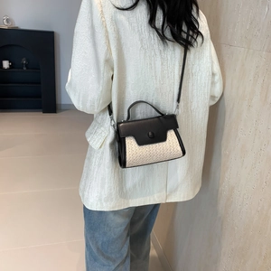 Contrast stitching straw handbag worn crossbody by model in white blazer and jeans