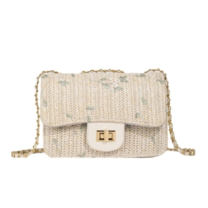 Beige woven straw shoulder bag with green floral embroidery and gold chain strap