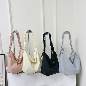 Large nylon hobo shoulder bags in pink, beige, black, and grey with ruffled straps