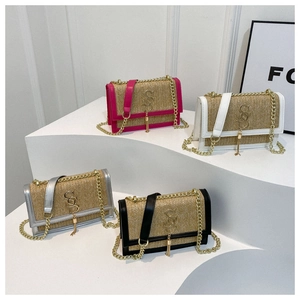 Close-up of woven straw small square bags with chain straps in four vibrant colors