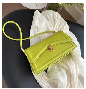 Detailed view of the lime green flap bag with geometric stitching and gold buckle