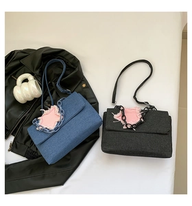 Detail view of denim star patch shoulder bags with thick chain straps in blue and black