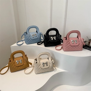 Quilted bucket handbags in five colors with silver bow hardware and adjustable straps