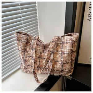 Detailed close-up of retro brown and beige tweed fabric texture on a large tote bag