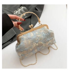 Detailed close-up of blue and gold jacquard fabric with vintage metal frame and handle