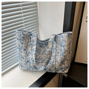 Detail of blue and white abstract ink print texture on oversized canvas tote bag