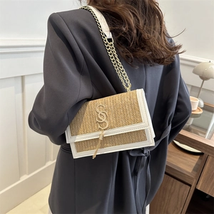 Woven straw and white leather crossbody bag with gold chain strap and tassel detail