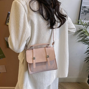 Chic pink suede shoulder bag with top handle and decorative silver metal studs