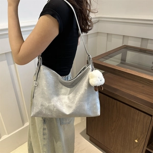 Silver large capacity hobo shoulder bag with metallic finish and cute lamb pendant