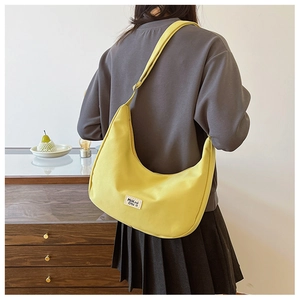 Detail of adjustable strap and yellow nylon canvas crescent hobo bag for women