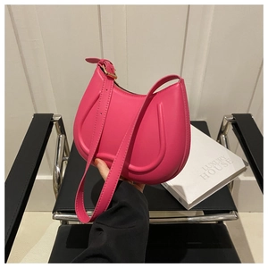 Detail of bright pink shoulder bag featuring a unique U-shaped embossed stitching pattern
