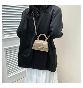 Detailed view of khaki PU leather mini square bag with top handle and crossbody strap
