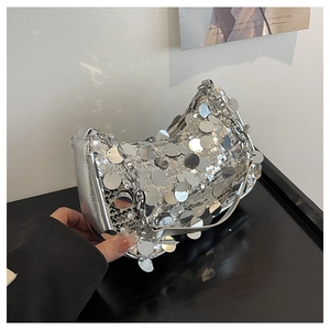 Close-up of silver sequin shoulder bag featuring large round sequins and metal chain