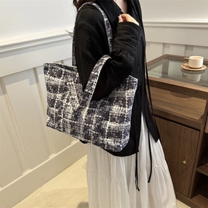 Large checkered tweed tote bag with black and white woven texture and dual straps