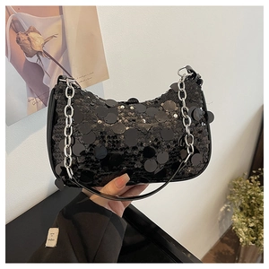 Detailed close-up of a black sequin handbag featuring a metallic silver chain strap