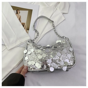 Detail of silver sequin shoulder bag with large round metallic discs and chain strap