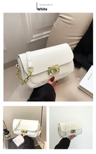 Detail of white leather shoulder bag with golden chain strap and metallic clasp