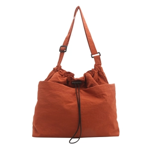 Large capacity orange nylon drawstring bucket bag with adjustable strap for commuting