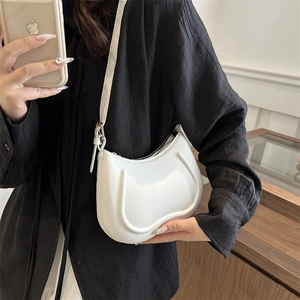 Minimalist ivory half-moon shoulder bag with U-shaped texture and metal zipper