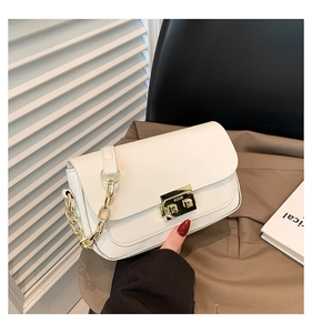 Close-up of a white leather shoulder bag with a gold rectangular buckle and chain strap