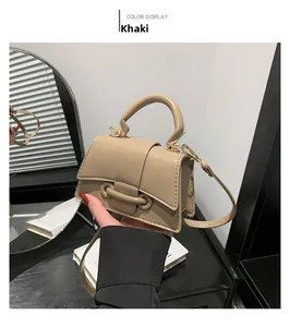 Detail view of khaki mini crossbody bag in glossy PU leather with metal buckle fastener