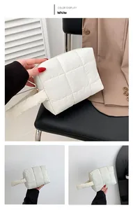 Close-up of white quilted puffer tote bag featuring soft padding and nylon texture