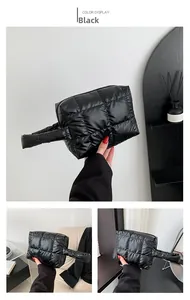 Detail showing black puffer tote bag with quilted square texture and padded handle