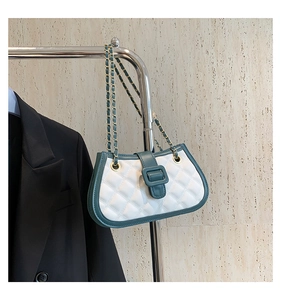 Detail of green and white quilted shoulder bag with gold chain and square buckle