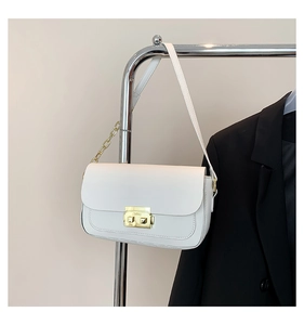 Close-up of minimalist white leather flap bag featuring gold clasp and metal chain detail