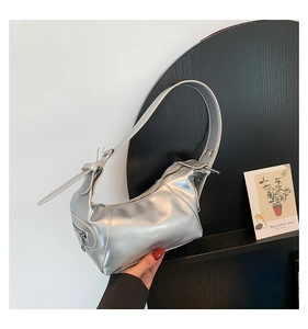 Detail of silver metallic hobo bag with adjustable strap and side zipper pocket
